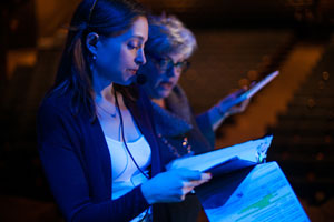 Christy Ney ’99 and Marybeth Abel, production stage manager for "Wicked," run lighting and technical cues before a show