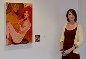Shannon Ehrola '13, standing beside her work, "Conversation"