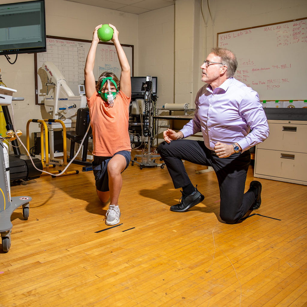 Teen does strength exercises in Faigenbaum's lab.